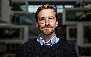 Portraitfoto von Prof. Dr. Daniel Fürstenau vor dunklem Hintergrund 